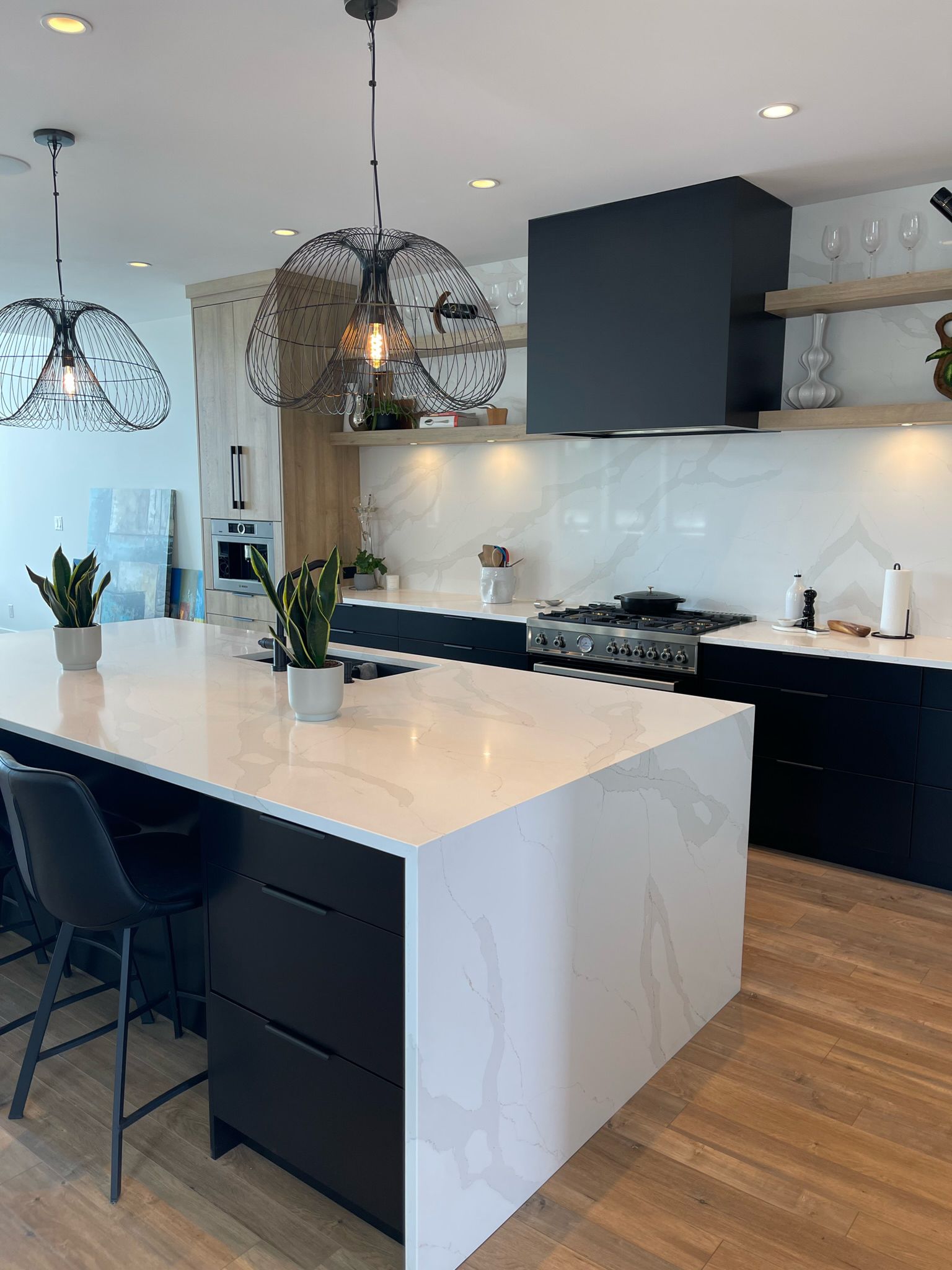 Black cabinetry · marble waterfall island