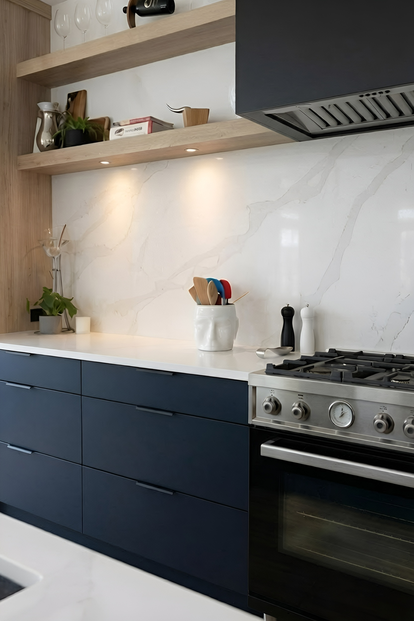 Navy cabinets · marble backsplash