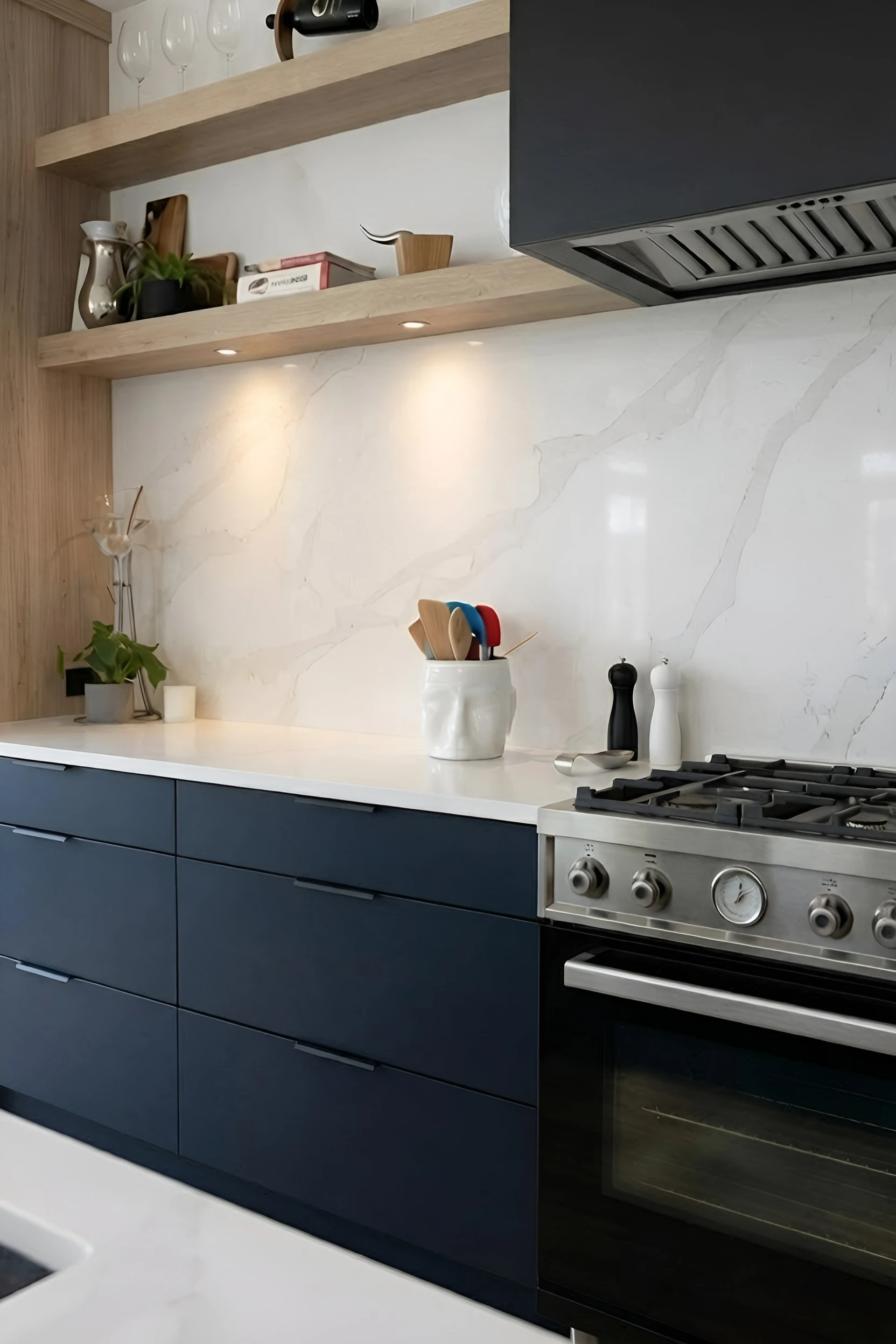 Navy kitchen · floating oak shelves