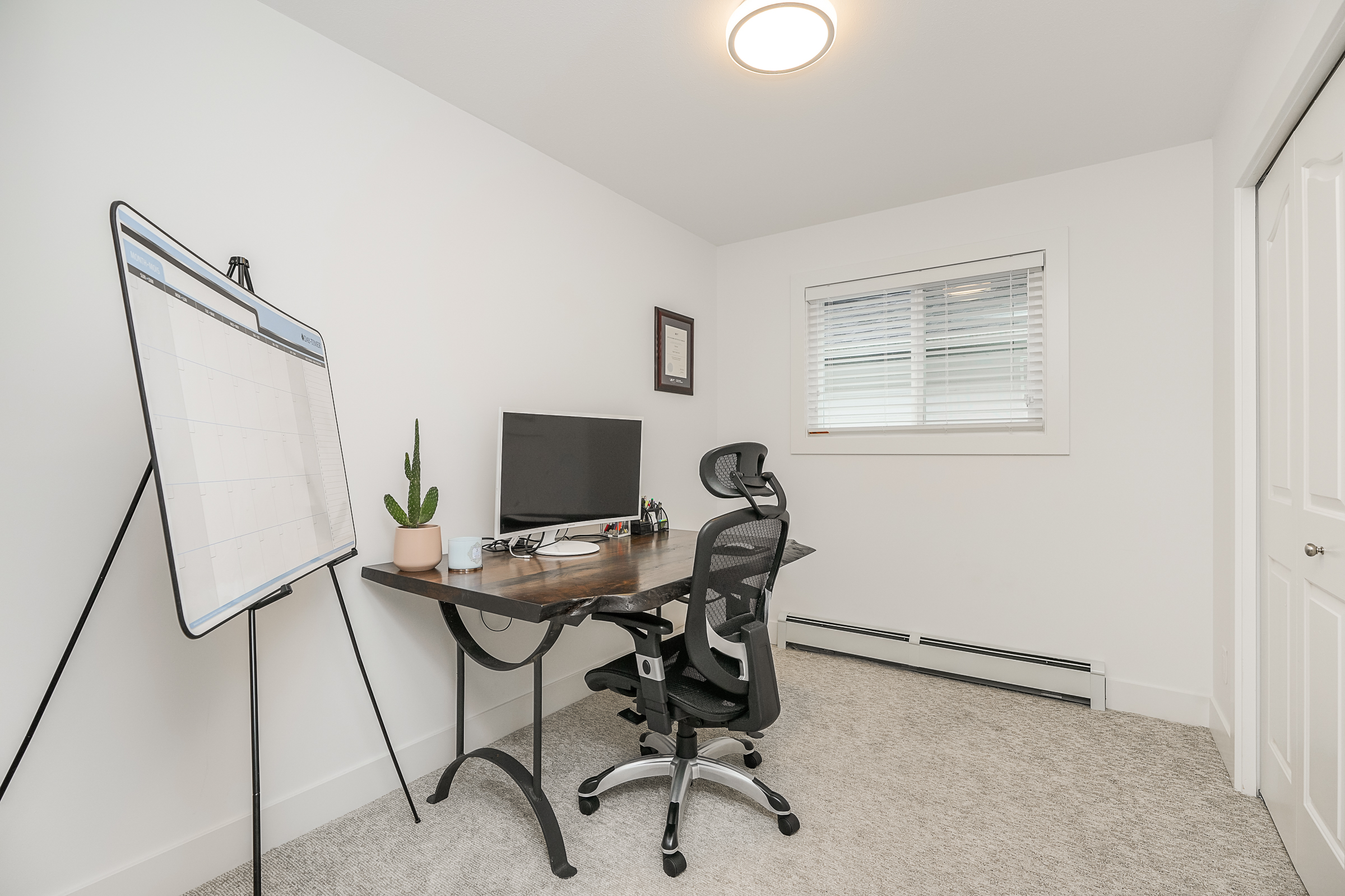 Home office with live-edge desk, ergonomic chair and natural light