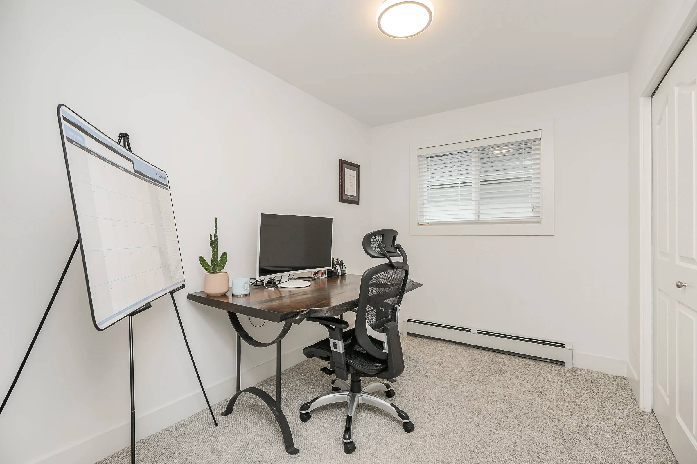 Home office with live-edge desk, ergonomic chair and natural light