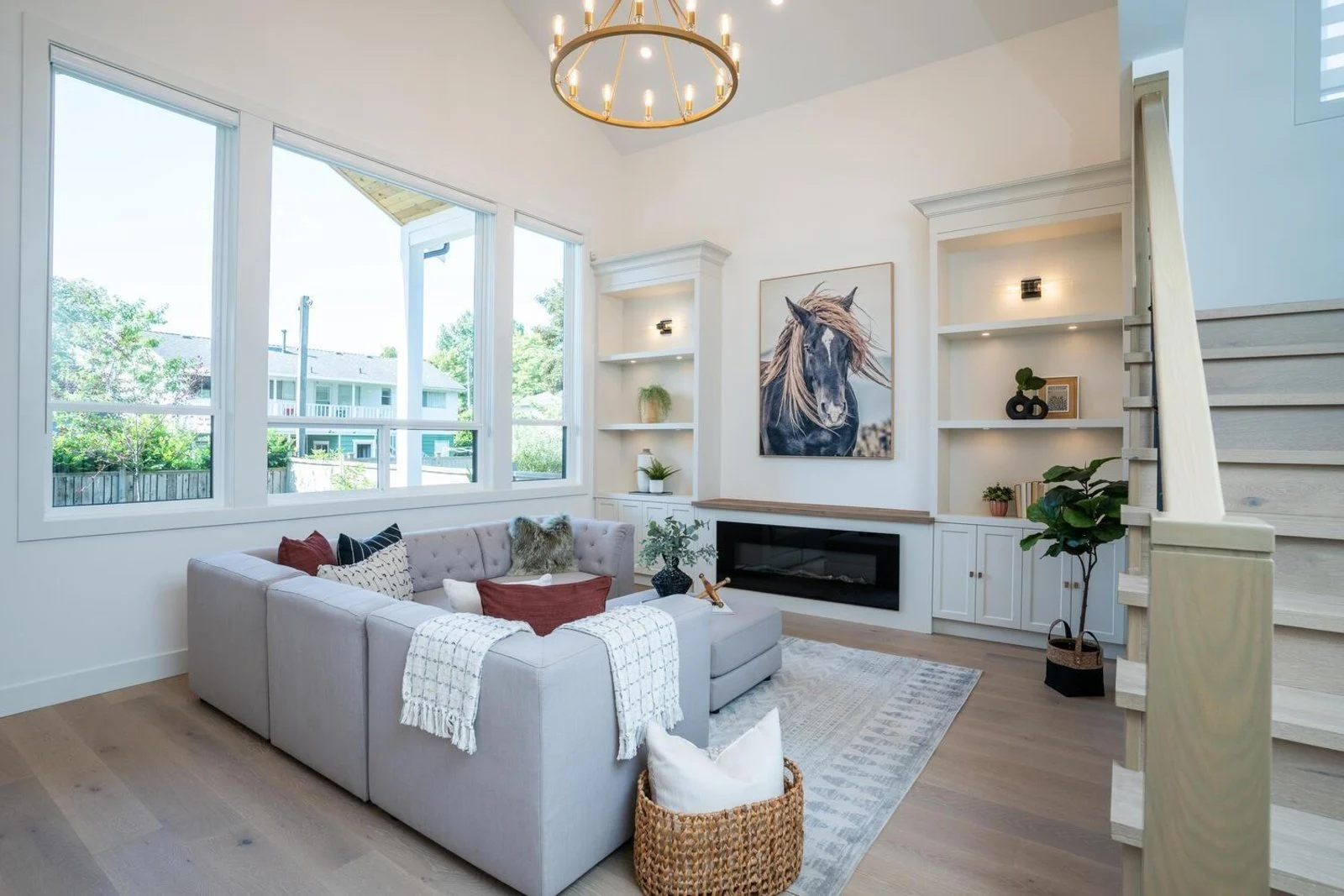 Open great room with two-story windows after structural reconfiguration