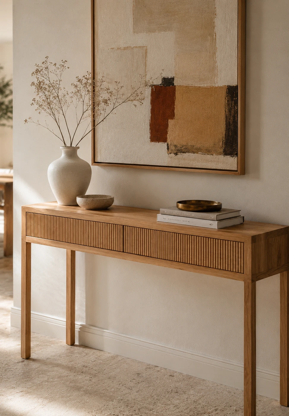Custom oak console table with fluted drawer fronts and abstract art above