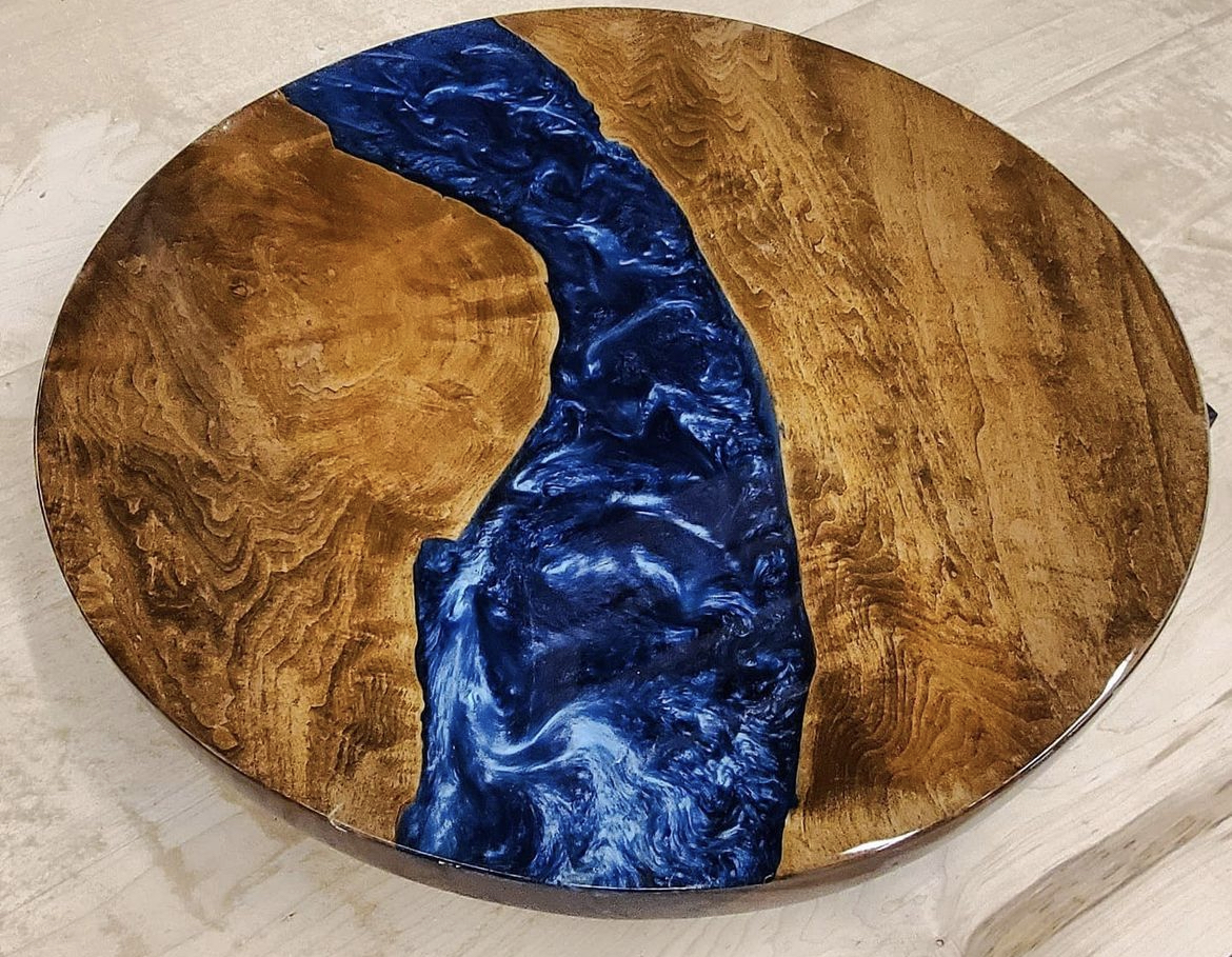 Custom round walnut and blue epoxy resin river table — Coastal Build Group millwork