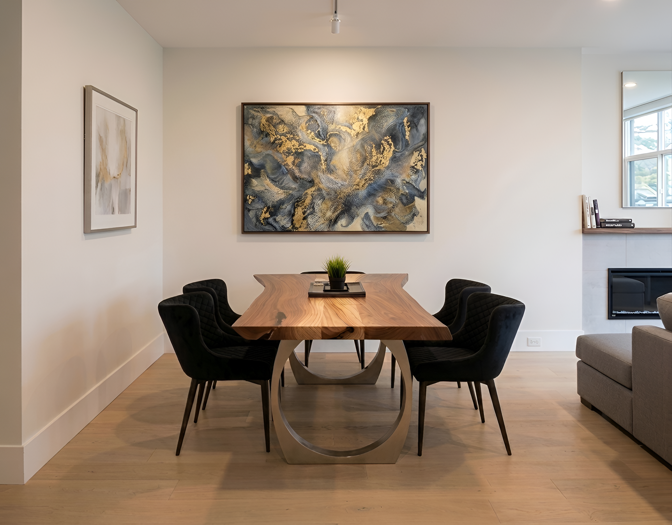 Dining room with live-edge walnut table, black velvet chairs and abstract gold-leaf artwork