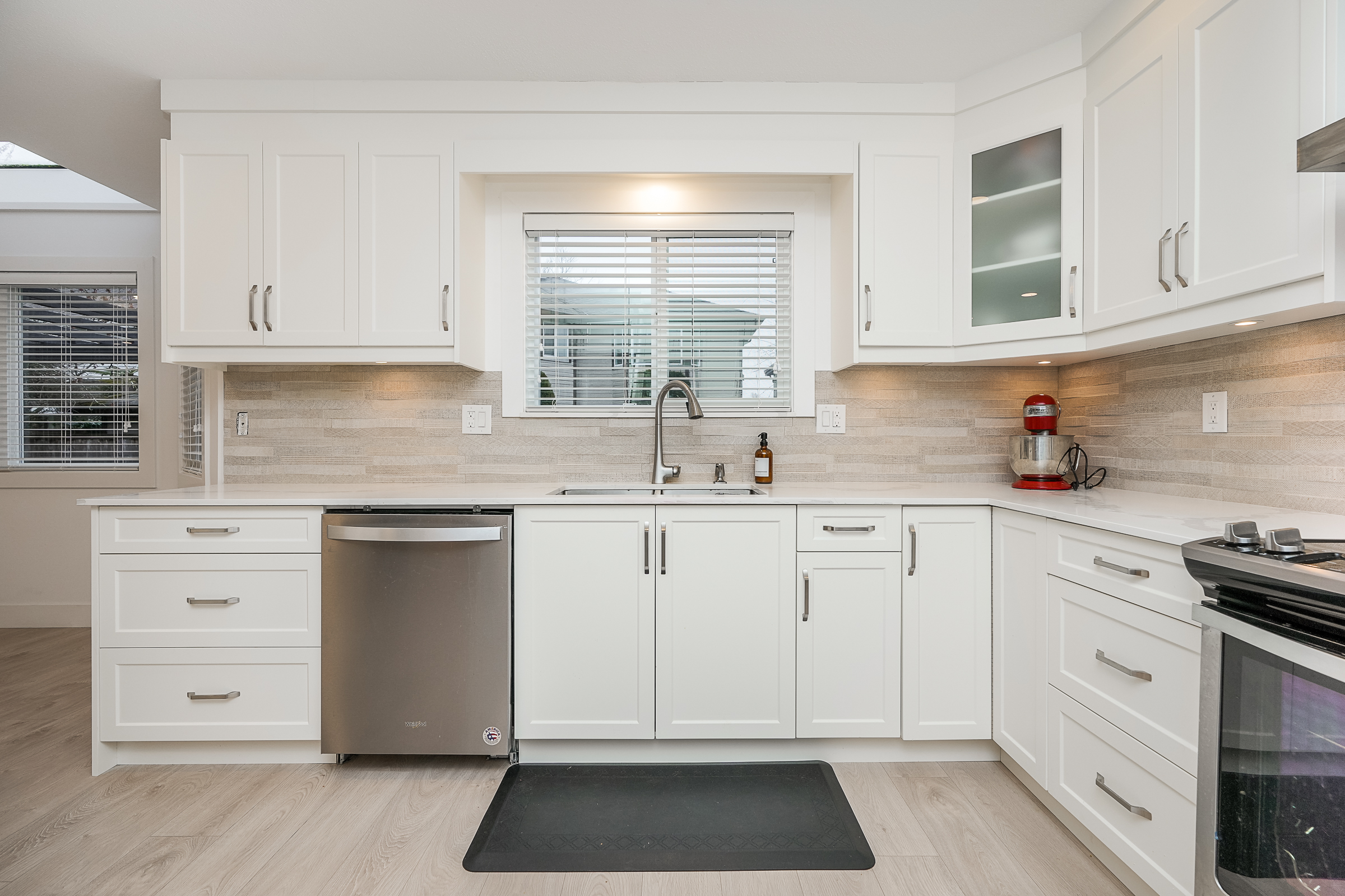 Bright Tsawwassen kitchen with white shaker cabinetry and large island