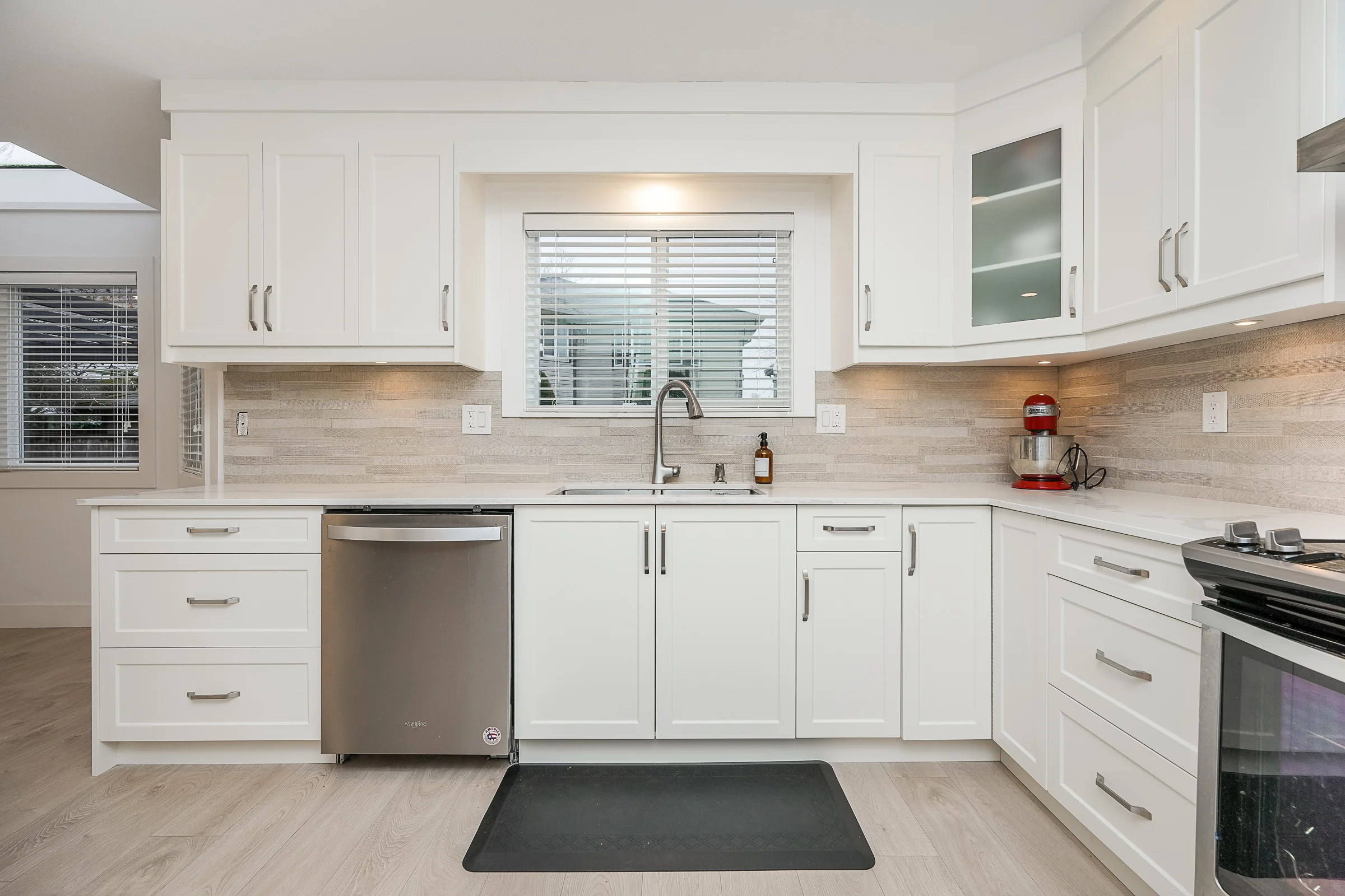 Bright kitchen with white shaker cabinetry and large island