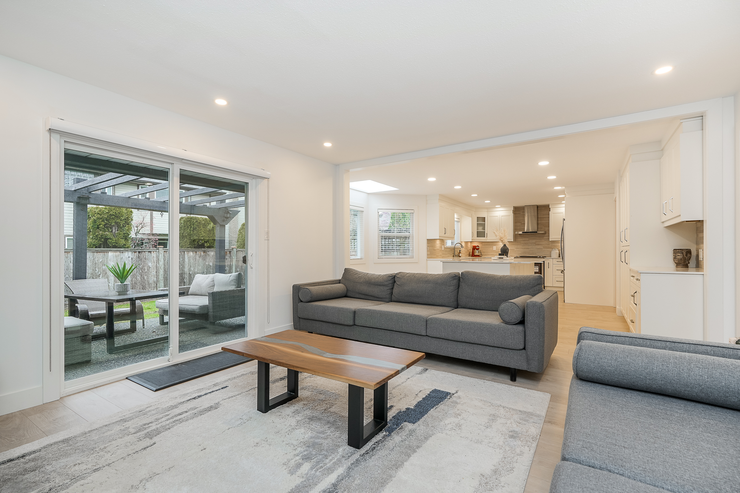 Reconfigured living area with marble fireplace, open to backyard