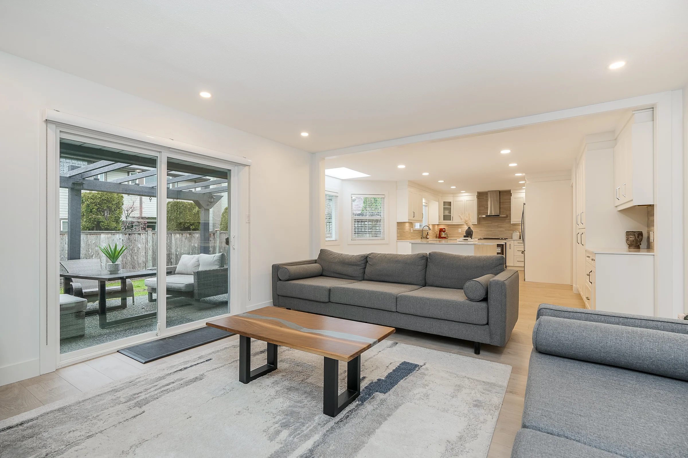 Reconfigured living area with marble fireplace, open to backyard